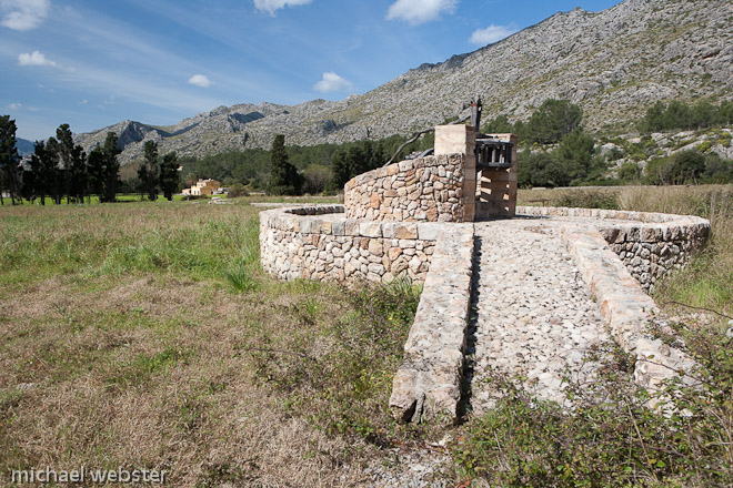 This type of ancient water well is common on the island and in times past was powered by a mule walking around the well, the water then being diverted to a complex system of irrigation pipes.